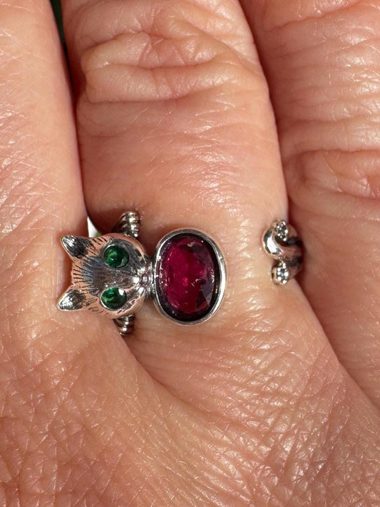 A sterling silver cat ring with a pink tourmaline gemstone, size 6.5 and adjustable, combines whimsical style with the charm of crystal healing jewelry.