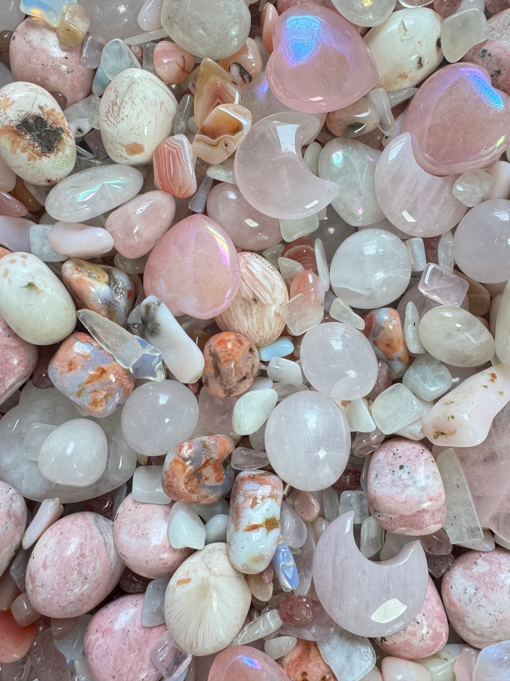 The PINK MOONGLOW MIX Crystal Confetti Scoop features a dreamy mix of polished pink moonglow, white, and light brown crystals in sphere, oval, and crescent moon shapes—all closely arranged like crystal confetti.