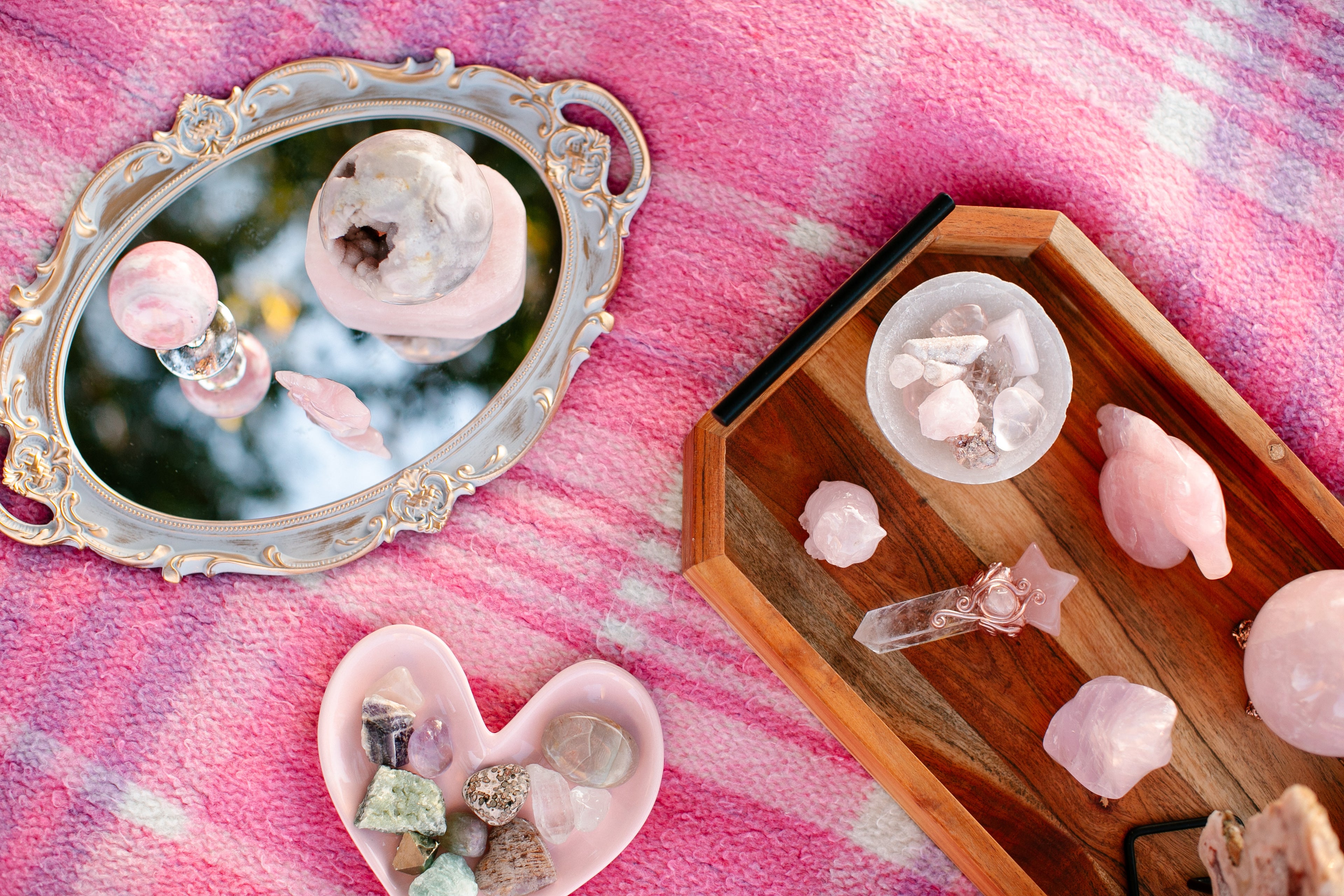 Decorative setting with crystal objects on a pink textured surface