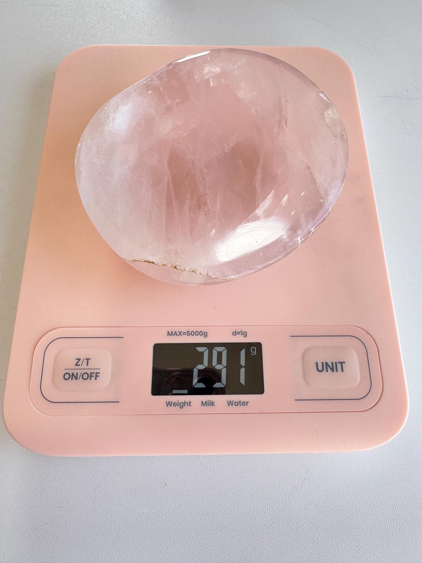 A Rose Quartz Bowl (ITEM B) in pale pink sits on a digital kitchen scale reading 781 grams—perfect for holding small tumbles, jewelry, or trinkets.